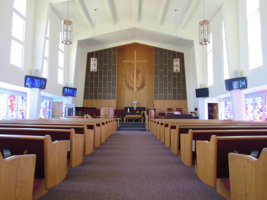 main church with pews, stained glass,