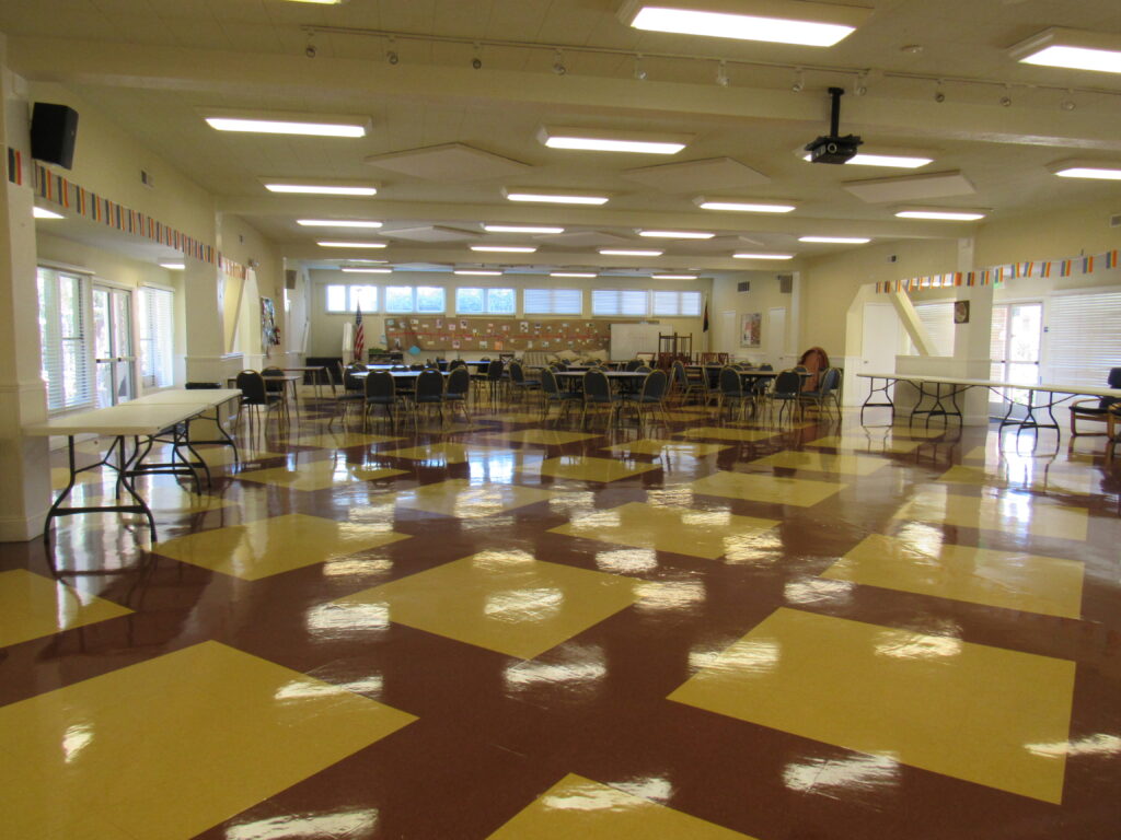 a large room with chairs and tables