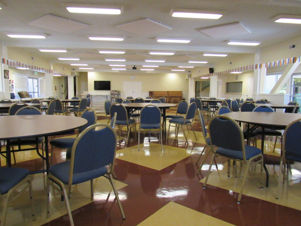 round tables and chairs in a large meeting room