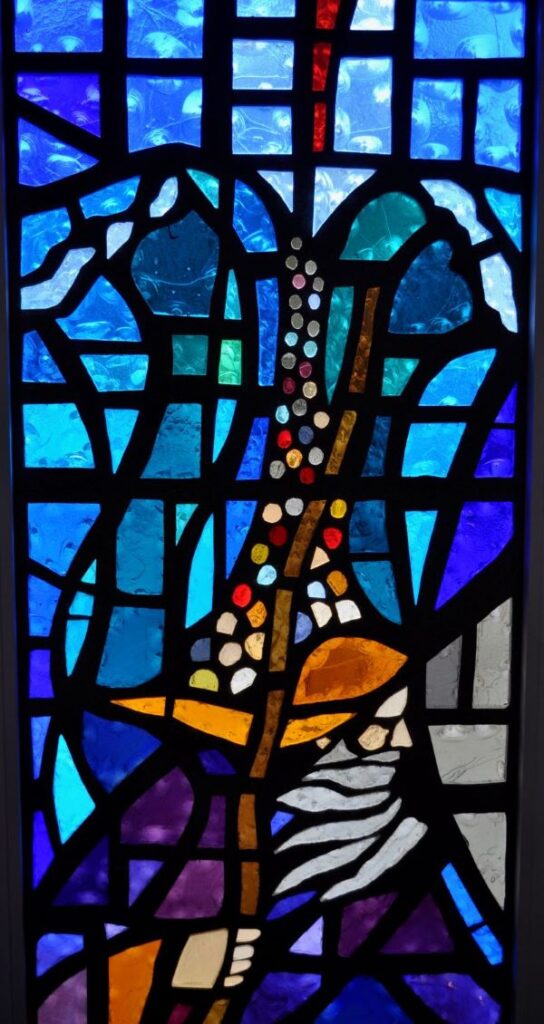 Stained glass window of a man splitting the ocean representing the Exodus story of Crossing the Red Sea