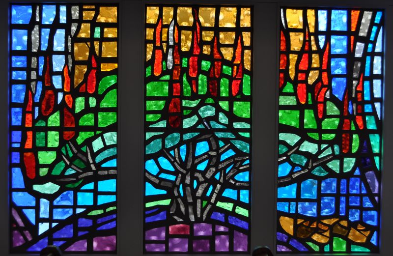 3 stained glass panels of a bush on fire representing the Exodus story of the Burning Bush