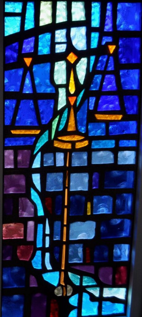 Stained glass window of water running representative of the Amos story of Justice Rolling down like water