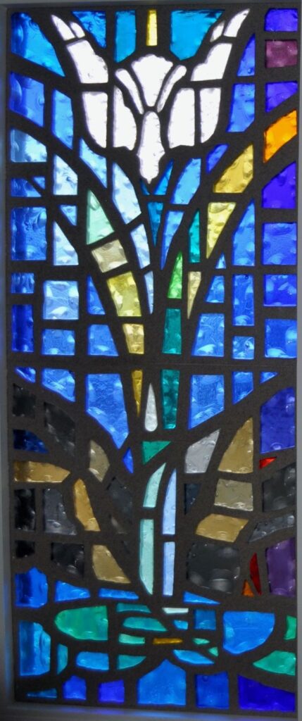 Stained glass window of a dove diving above water representative of the Matthew and Mark stories of the Baptism of Jesus